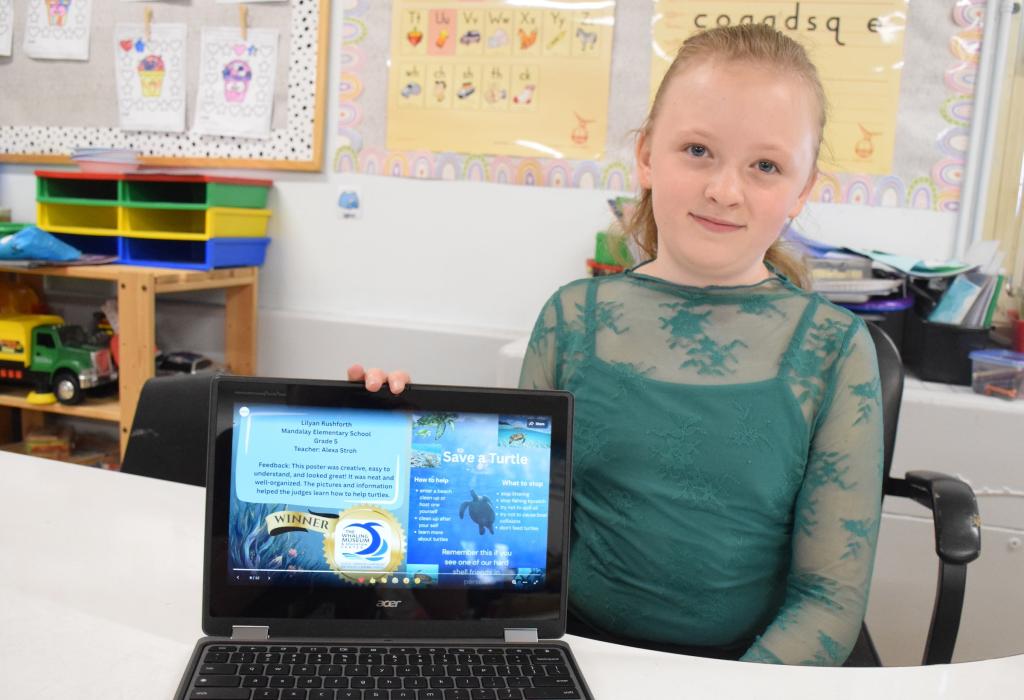 girl sitting holding laptop